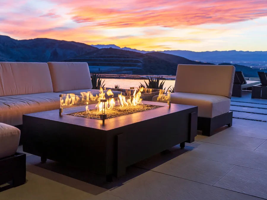 An American Fyre Designs fire table on a terrace at sunset