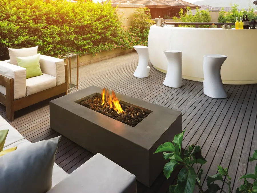 A Napoleon Patioflame fire table on a wood deck