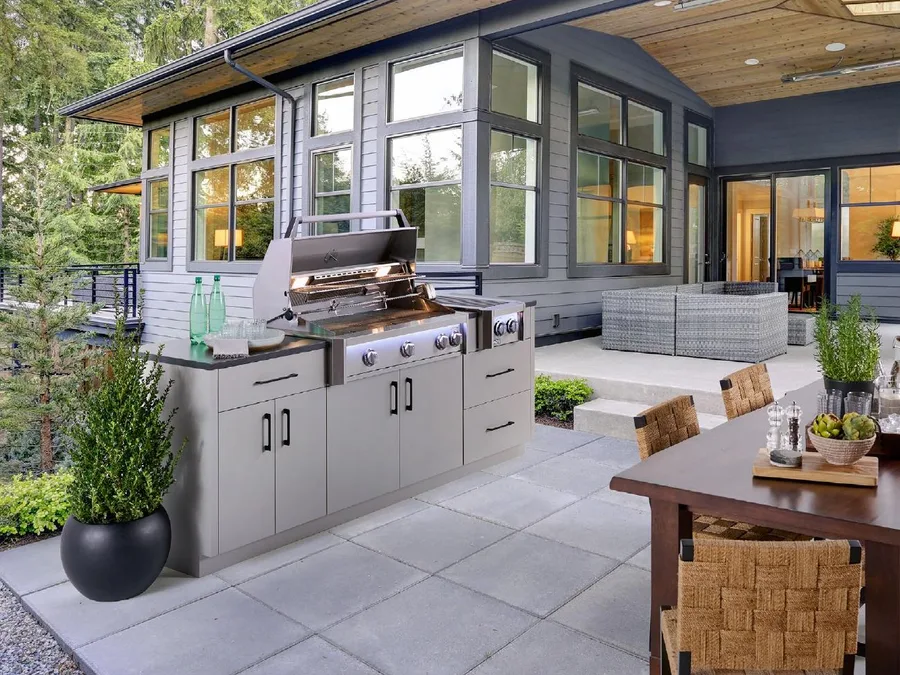 An American Outdoor Grill built into a cabinet island on a covered patio