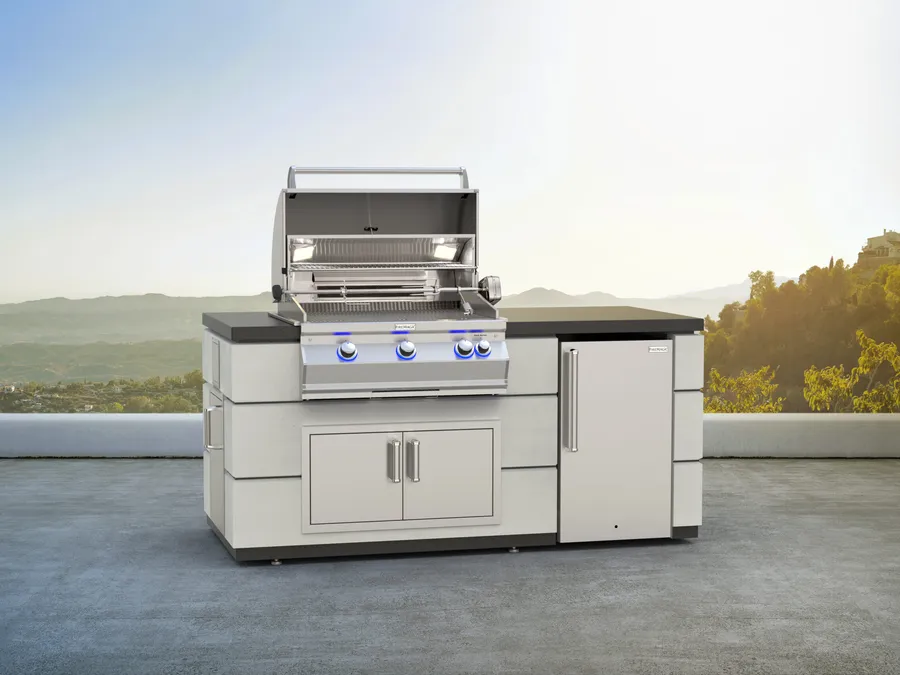 A Fire Magic grill in an outdoor kitchen island on a hillside terrace