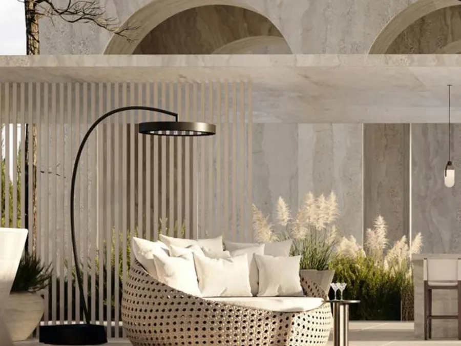 A Bromic Eclipse free-standing heater beside a daybed by a pool